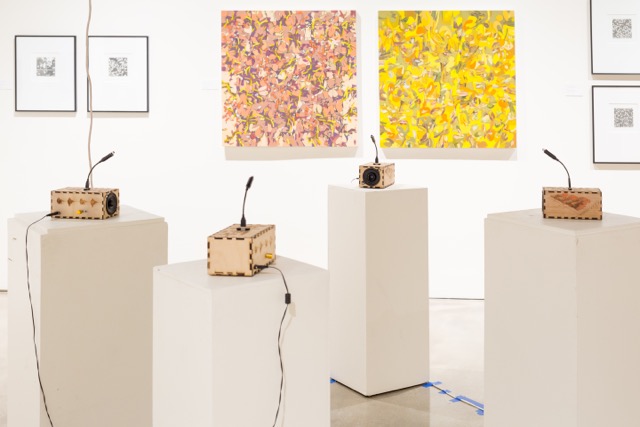 Four Sonic Mirrors on pedestals in an art gallery.