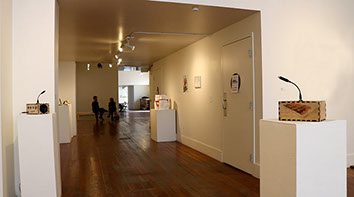 Two Sonic Mirrors positioned 3m apart, facing each other on white display pedestals at the Root Division art gallery.