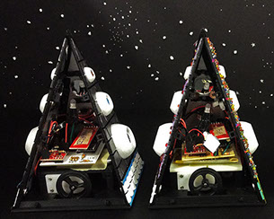 Exposed interior of two Musical Melodyian robot prototypes. Each robot contains an Arduino, LED, two wheels, and other electronics.