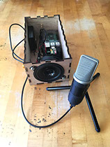 Exposed interior of Sonic Mirror speaker enclosure next to microphone.
